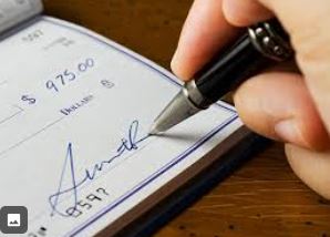 Buyer signing a home purchase contract and providing earnest money deposit – Cindy Burkhardt Realtor Citrus County