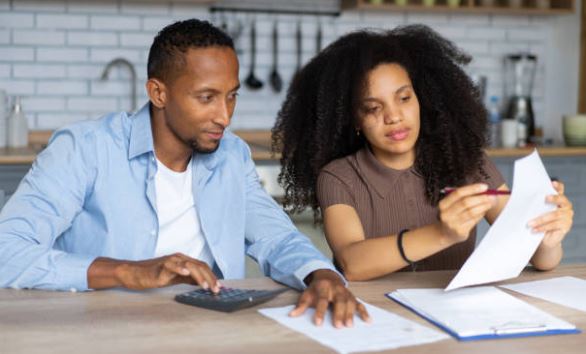 Citrus County homeowners reviewing monthly expenses and planning post closing costs at their kitchen table