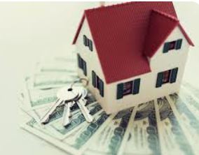 Closing costs shown with a small house model and keys placed on top of hundred dollar bills