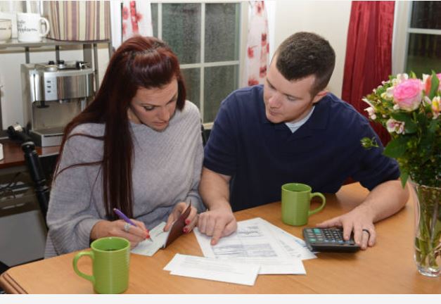 Couple reviewing their finances, paperwork, and down payment options while budgeting at home in Citrus County.