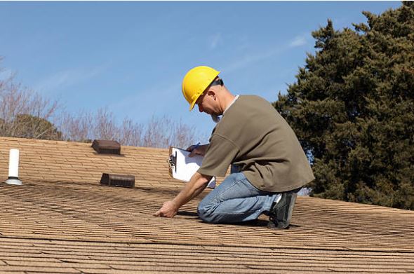 Inspector checking roof attachments during a wind mitigation inspection in Citrus County Florida