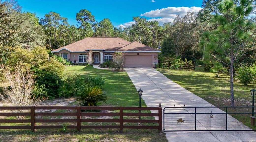 Pine Ridge home for sale — relisted with the best agent Pine Ridge, featuring acreage, mature landscaping, and private gated entry.