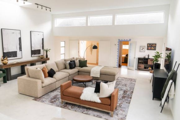 Staged living room with neutral Staged living room with neutral furniture and natural light showing move in ready presentation before selling a home.
