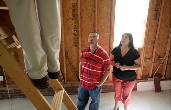 Couple observing a home inspector during a pre listing inspection Citrus County sellers often complete before listing