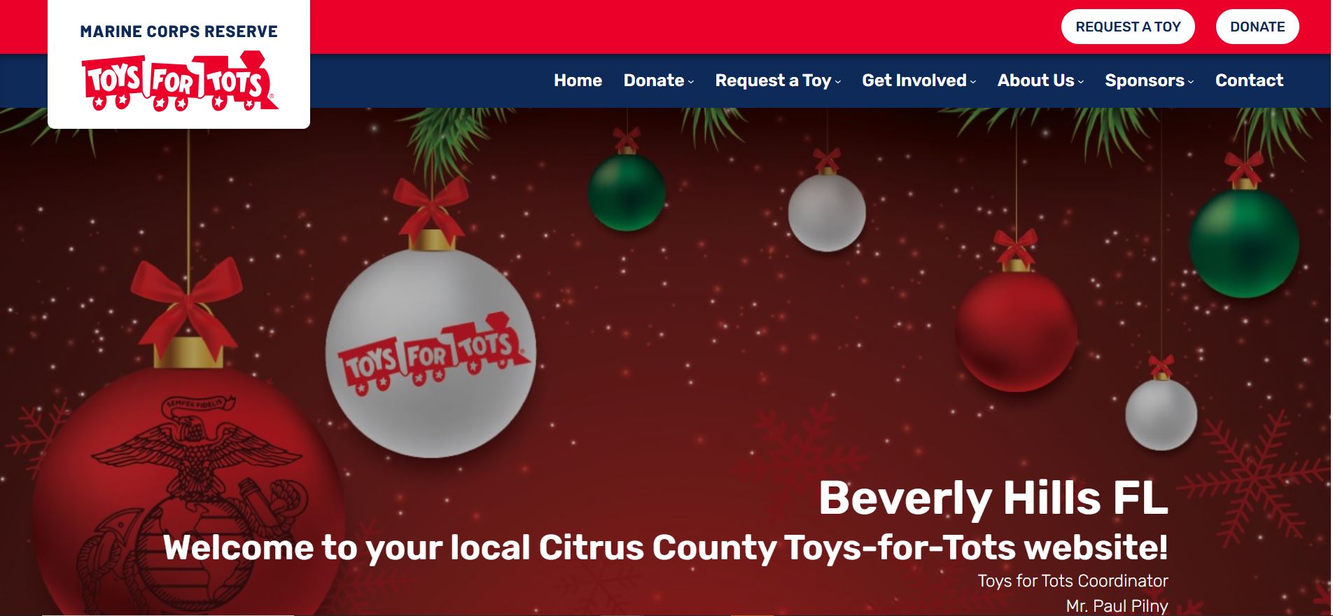 Red and green Toys for Tots holiday background with ornaments